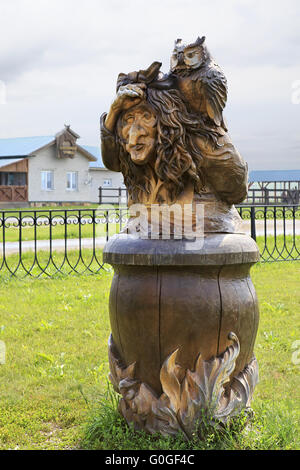 Baba Yaga in a mortar. Wooden sculptures based on Pushkin's fairy tales. Stock Photo