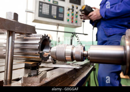 Man operating CNC drilling and boring machine. Industry Stock Photo