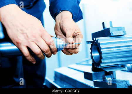 Man working on drilling and boring machine. Industry Stock Photo
