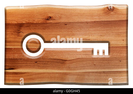 Key symbol cut in wooden board isolated on white Stock Photo