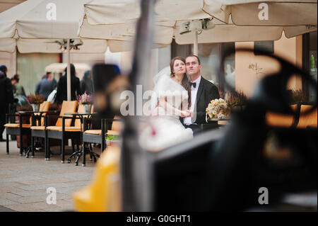 Young elegant and hearty wedding couple in love on streets of Krakow, Poland Stock Photo