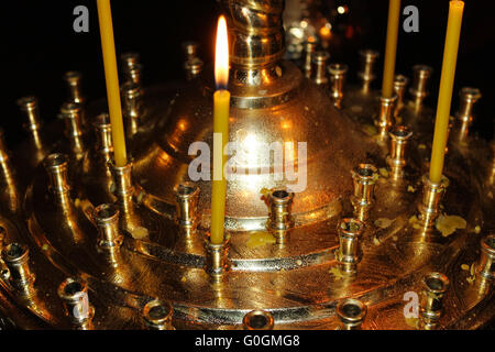 Candles burning in the golden candlestick in the church Stock Photo