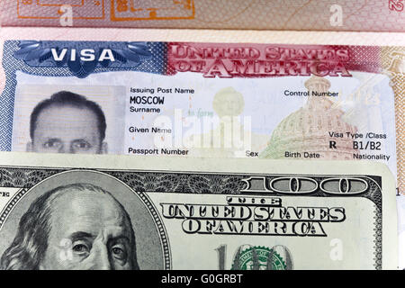 American visa on page of the Russian international passport and US dollars Stock Photo