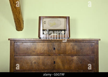 old radio on the old chest of drawers Stock Photo