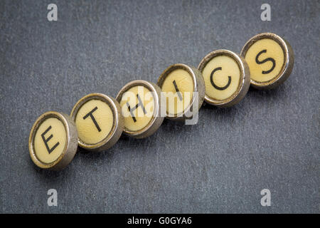 ethics word in old typewriter keys against gray slate stone Stock Photo