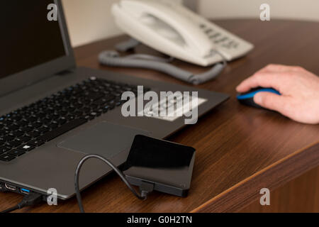 Person created on an external hard drive to backup to save data Stock Photo