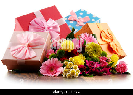 Composition with bouquet of flowers and gift boxes isolated on white Stock Photo