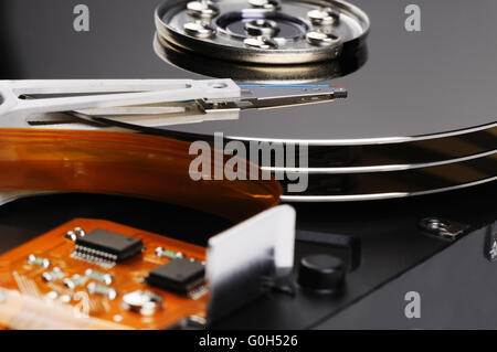 Taken apart computer hard disk drive (HDD) background Stock Photo