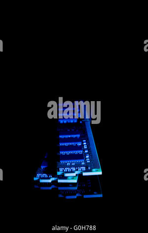 Computer random access memory (RAM) modules on the black background toned blue Stock Photo