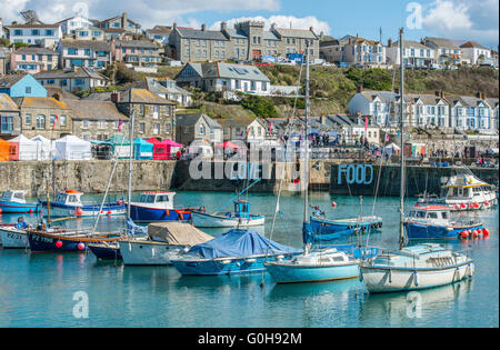 Porthleven Inner Harbour with boats moored during the April 2016 Food Festival, in Cornwall on a sunny day Stock Photo