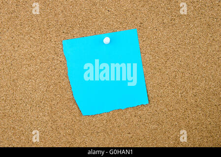 Blank turquoise paper note pinned on cork board with white thumbtack, copy space available Stock Photo