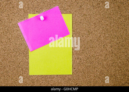 Blank paper notes pinned on cork board with thumbtack, copy space available Stock Photo