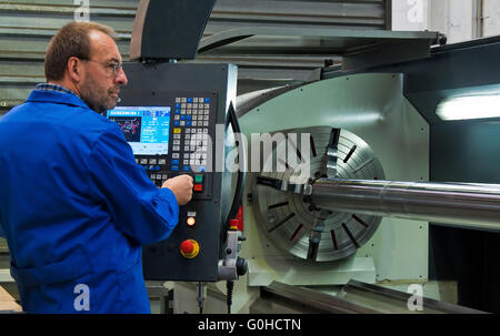 Older workers in the metal industry in CNC milling machine. Stock Photo