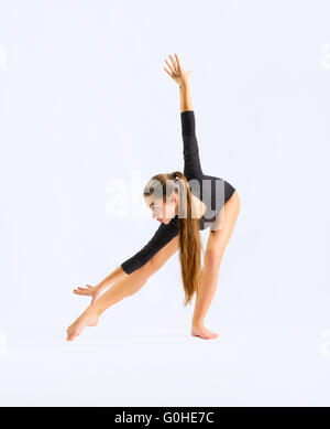 Young girl engaged art gymnastic on grey Stock Photo