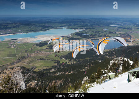 Paraglider sequence gray orange in Bavaria Stock Photo