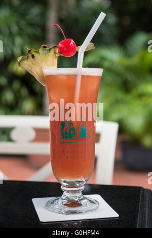 Singapore Sling Cocktail served in a Hurricane Glass with Maraschino Cherry Pineapple Slice, Raffles Hotel, Singapore Stock Photo
