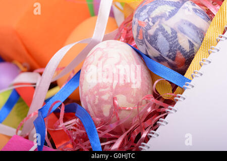 Arrangement of Gift Boxes in Wrapping Paper with Checkered Ribbons and Decorated Easter Eggs isolated on white background Stock Photo