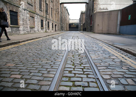 Original Cobblestone streets outside the Guinness Storehouse brewery in Dublin Ireland with old tram lines Stock Photo