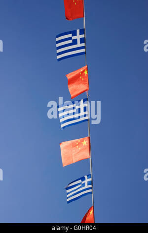 Greek and Chinese country flags serve as decorative elements waving overhead in China town streets, Vardaris district, Salonika Stock Photo