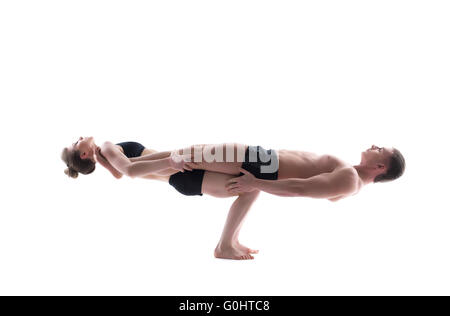 Couple of flexible gymnasts balancing in studio Stock Photo