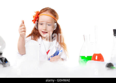 Adorable girl doing experiment, isolated on white Stock Photo