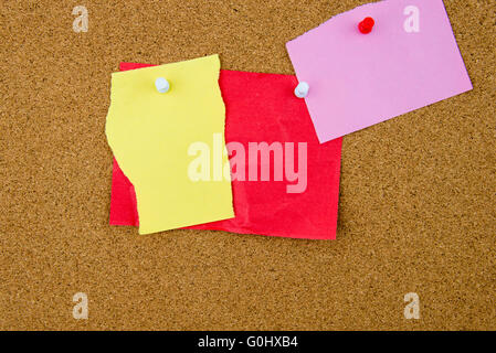 Blank paper notes pinned on cork board with thumbtacks, copy space available Stock Photo