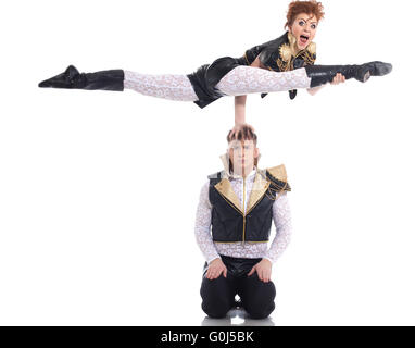 Emotional go-go performers doing acrobatic trick Stock Photo