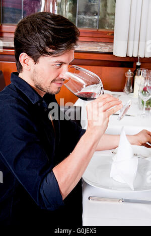 couple drinking red wine in restaurant Stock Photo