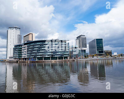 The Salford Quays with the metrolink trams was once Manchesters Docks but now it hosts Mediacity,the Lowry and the IMPWar Museum Stock Photo