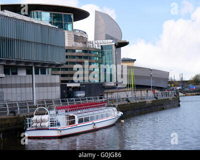 The Salford Quays with the metrolink trams was once Manchesters Docks but now it hosts Mediacity,the Lowry and the IMPWar Museum Stock Photo