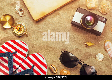 Summer holiday vacation accessories on beach sand, summertime lifestyle objects in flat lay top view arrangement. Stock Photo