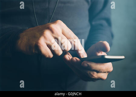Man sending text message, sms communication using mobile smartphone Stock Photo