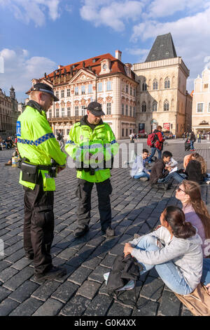 Old Town Square, Prague, Czech Republic, May 2, 2016. For feeding pigeons in a public place a disciplinary fine. Three young girls (pictured) from Poland in the Kiosks bought sausage with mustard and bread. The remaining bread, then threw pigeons. For them municipal police officers fined 300 Czech crowns (around 11 euros) each. In the case of non-payment would be a protocol, and possibly fines could reach up to 5,000 Kc. The policemen were very uncompromising and Girls paid. Stock Photo