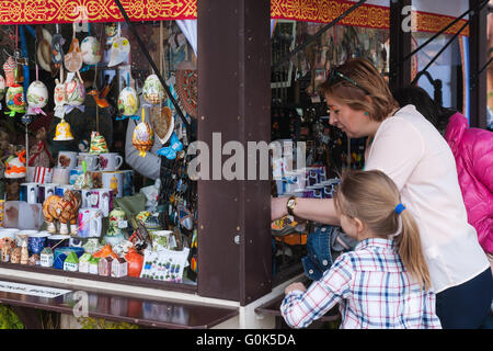 Russia, Moscow Spring Festival continues in the streets and squares of Moscow on May 02, 2016. The festival is associated with a number of Russian holidays: Russian Orthodox Easter and Worker's Day which are to be celebrated on May 1, and Victory Day, May 9. Streets and squares of Moscow are cheerfully decorated for good spirits. Unidentified woman buys souvenirs during the festival. Credit:  Alex's Pictures/Alamy Live News Stock Photo