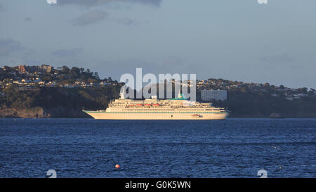 Torbay, Devon, UK, 02 May 2016. The German cruise liner MS Albatros, on a 9 day cruise, visits Torquay in Devon on the May Day Bank Holiday. The large liner anchored in Torbay and passengers were ferried to Torquay; the last of boat-load of which can be seen being winched on-board towards the rear of the ship. Credit:  Clive Jones/Alamy Live News Stock Photo