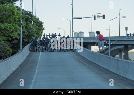 Seattle, WA, USA. 1st May, 2016. One of protesters walks on a ledge where the area has been closed off by a law enforcement. Stock Photo