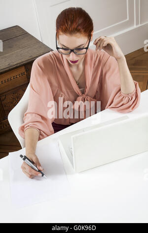 Young Businesswoman Looking at Computer Seriously Stock Photo