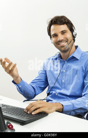 Man wearing headset giving online chat and support Stock Photo