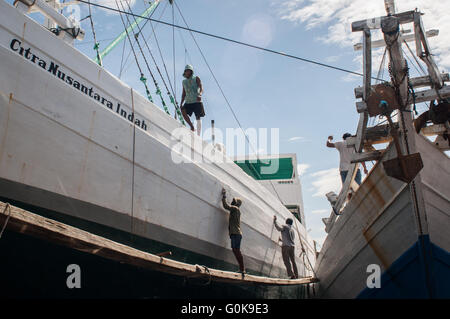 Workers clean the boat at Paotere Port in Makassar, Indonesia. Stock Photo