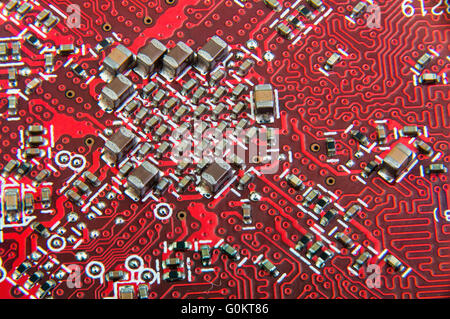 Electronic circuit board close up. Red PCB Stock Photo