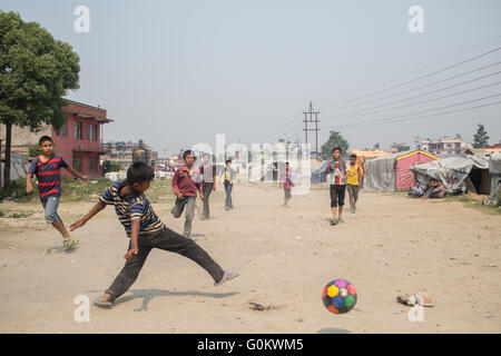 Some children in playing football in one of Kathmandu´s earthquake camps. Stock Photo