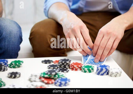 close up of male hand with playing cards and chips Stock Photo