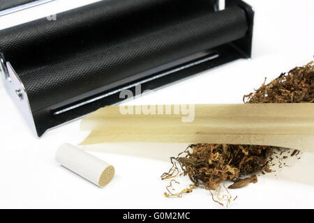 Tobacco with filter, rolling machine, paper isolated on white background Stock Photo