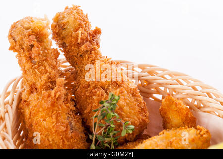 Crisp crunchy golden chicken legs and wings Stock Photo