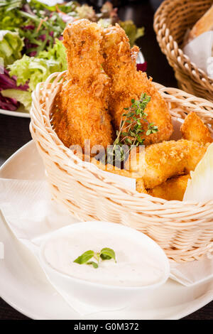 Crisp crunchy golden chicken legs and wings Stock Photo