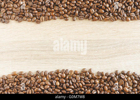 Borders made from coffee beans with space for text on wooden background Stock Photo