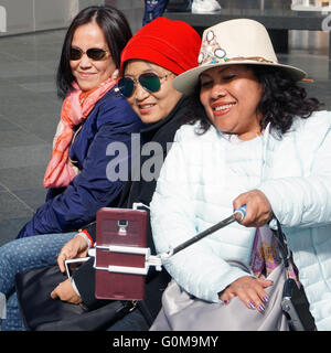 Selfie Three mature asian female friends taking smartphone selfie Stock Photo