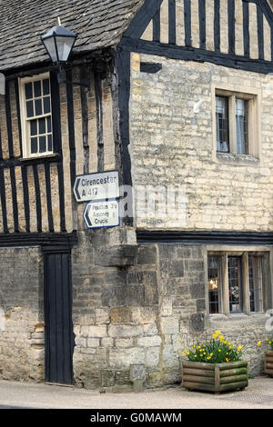 Directions to Cotswold towns and villages on an ancient half-timbered building in Fairford, Gloucestershire, England, UK. Stock Photo