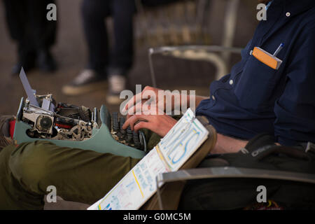 man typing on a typewriter Stock Photo