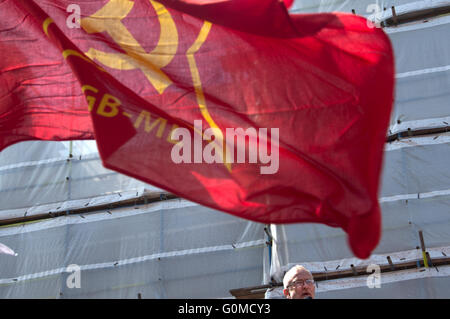 Mayday 2016. Clerkenwell. Jeremy Corbyn, MP, leader of the Labour Party speaking at a rally before the march, under a red flag. Stock Photo